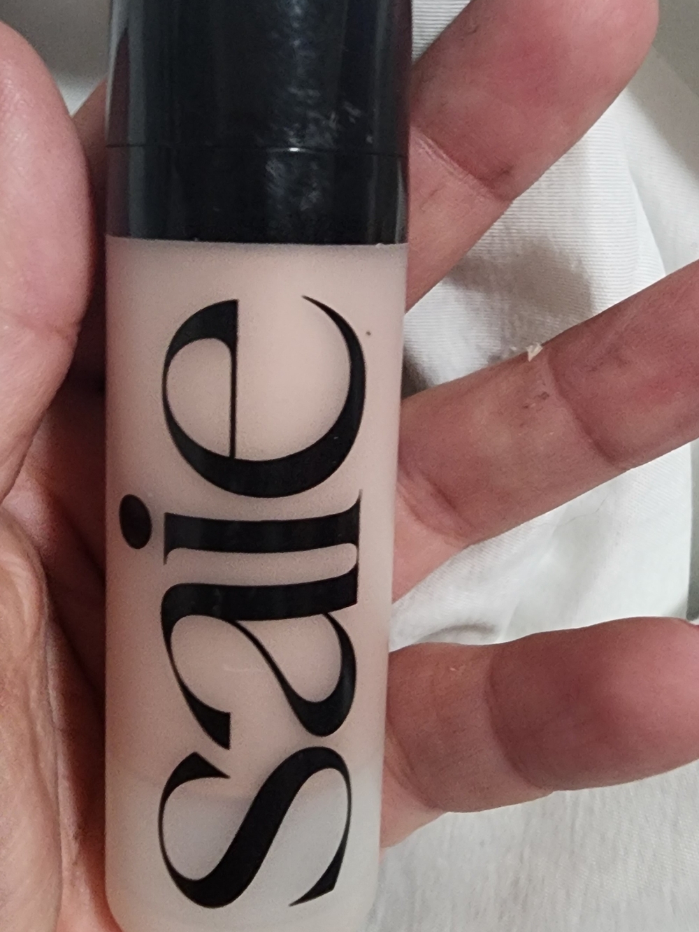 Saie Tinted Primer Bottle in Light Beige with Black Cap